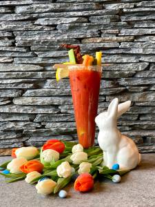 White rabbit figuring next to a bloody mary.