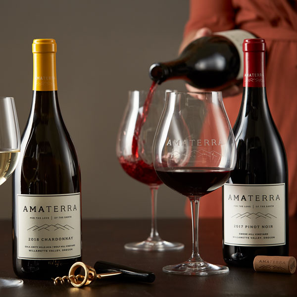 Amaterra wine bottles and a glass of red wine being poured.