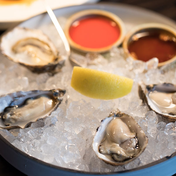 Oysters on ice with lemon wedge