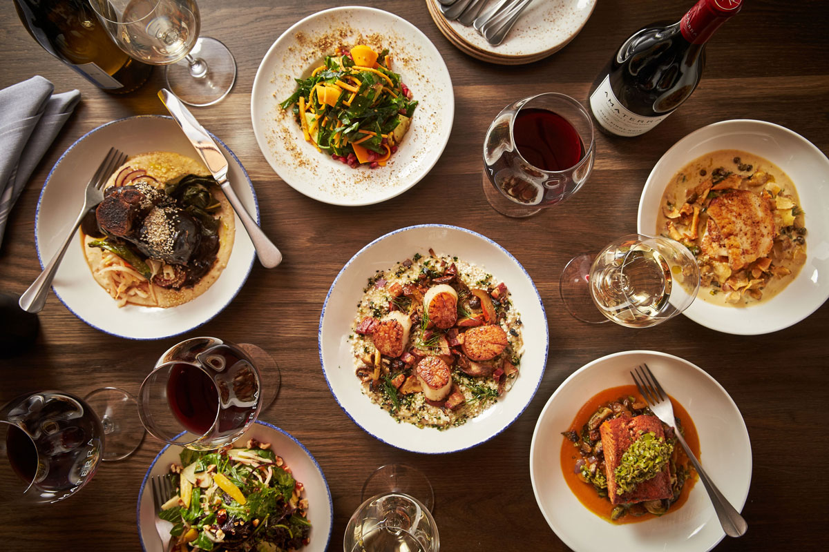 Family style dinner on a table with amaterra wine